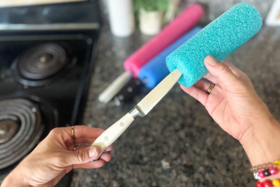 putting knife into pool noodle