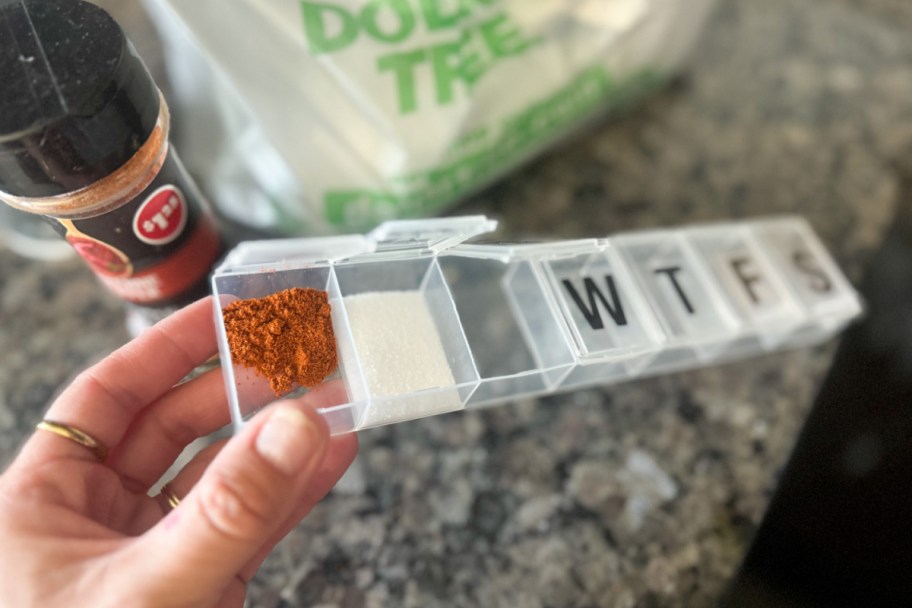 hand opening pill container with spices