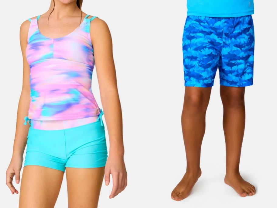a girl wearing a free country pink and green tankini swim set and a boy wearing a free country blue shark swim short
