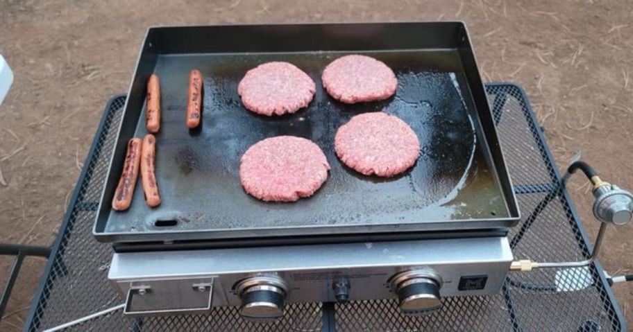 member's mark griddle outside with hot dogs and hamburgers on it