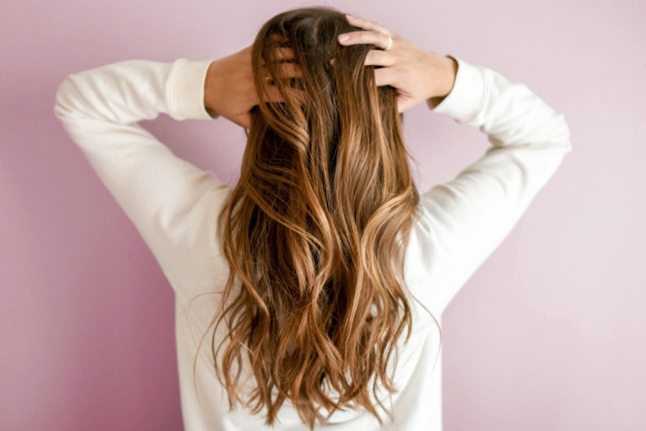 woman showing back of head holding hair