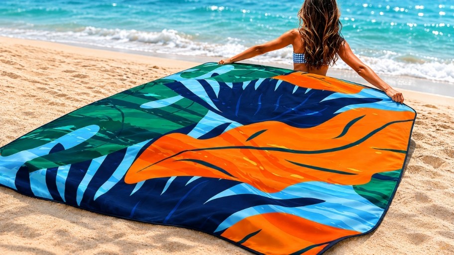 a woman on a beach with a beach blanket