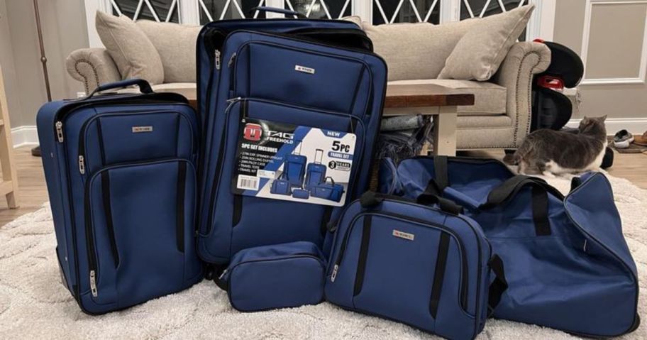 blue luggage set in living room