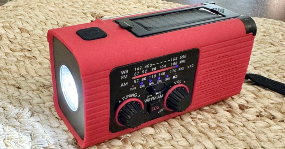 red and black emergency radio on table
