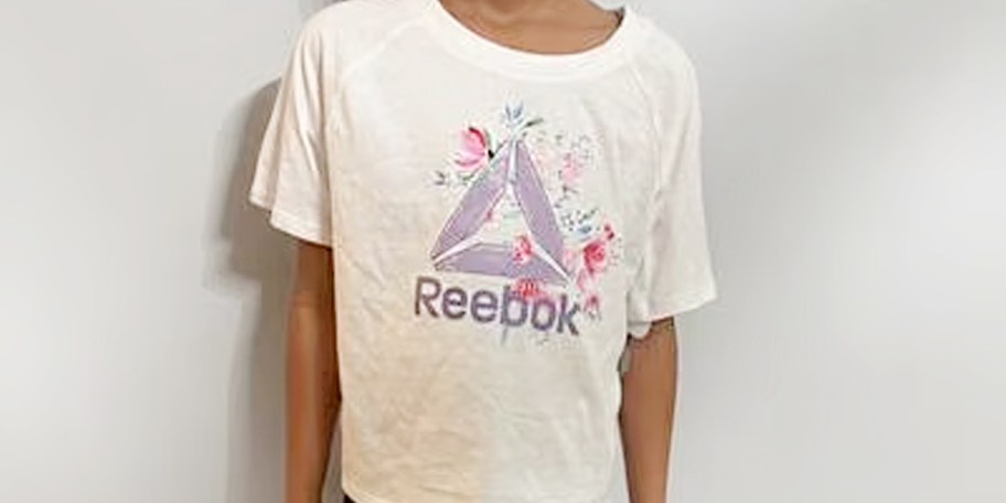 girl wearing white floral reebok tee 
