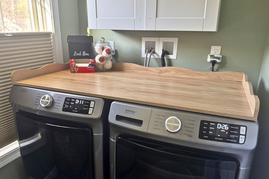 an oak colored washer and dryer countertop