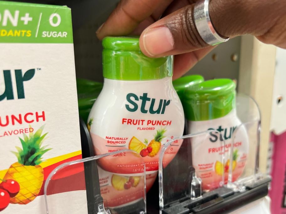 Stur Liquid Water Enhancer in Fruit Punch in hand in store