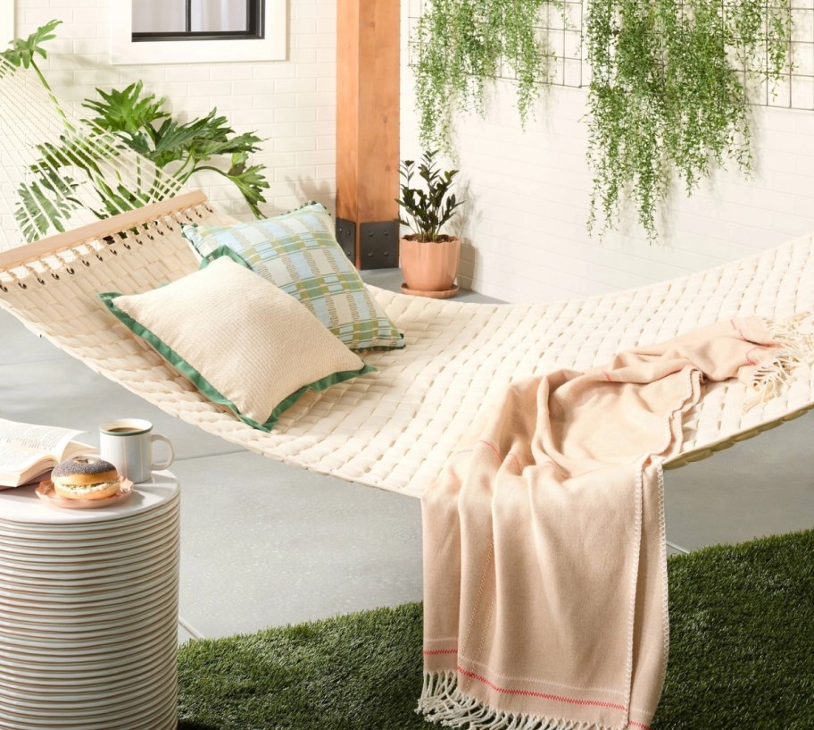 a two person hammock shown with throw pillow and throw