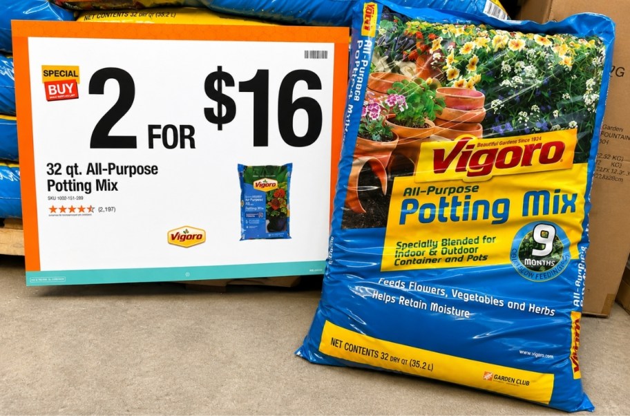 a bag of potting soil in a garden center next to sale signage