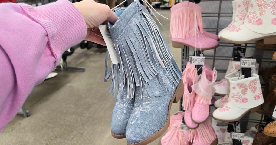 hand holding blue boots 