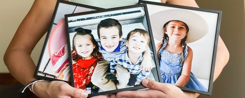 3 TilePix Prints from Walgreens being held by a woman