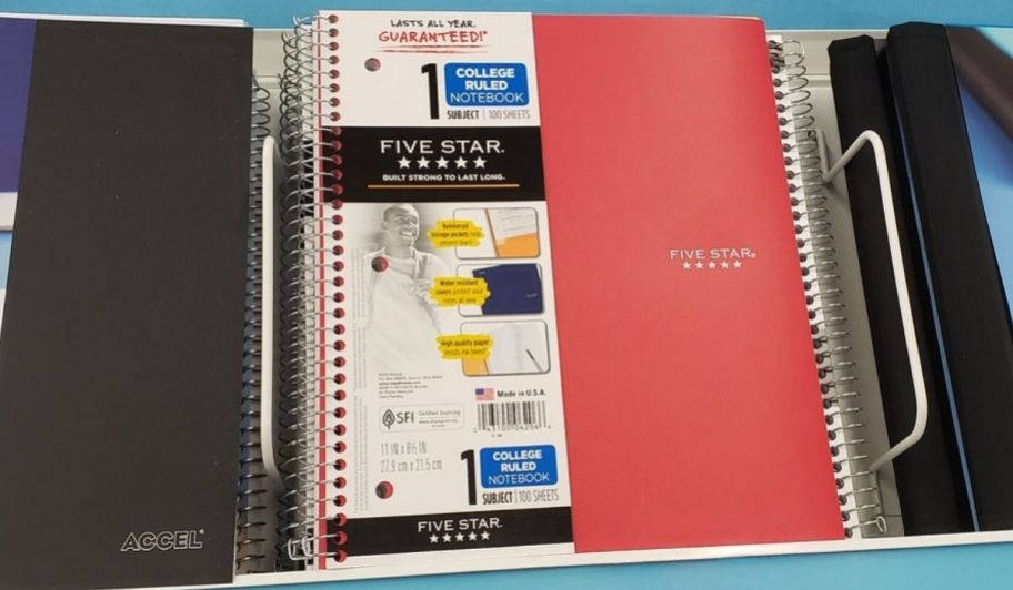 a red single subject note book on a store shelf