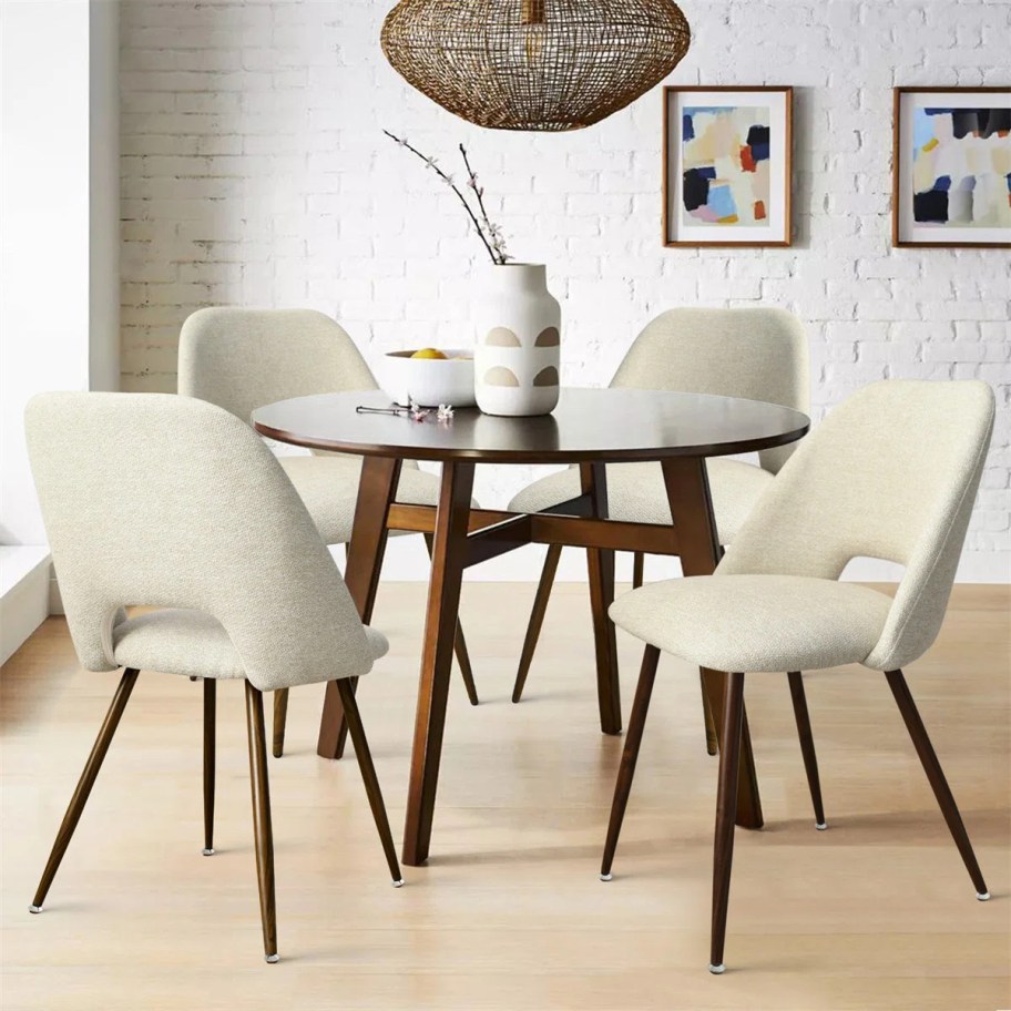 Round dining room table with white upholstered chairs 