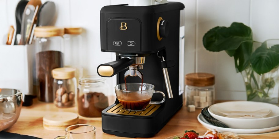Beautiful by Drew Slim Espresso Machine in Black on a counter with jars and plates