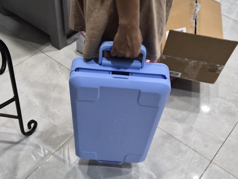 person holding Coleman Snap 'N Go 45-Qt Collapsible Cooler while folded up