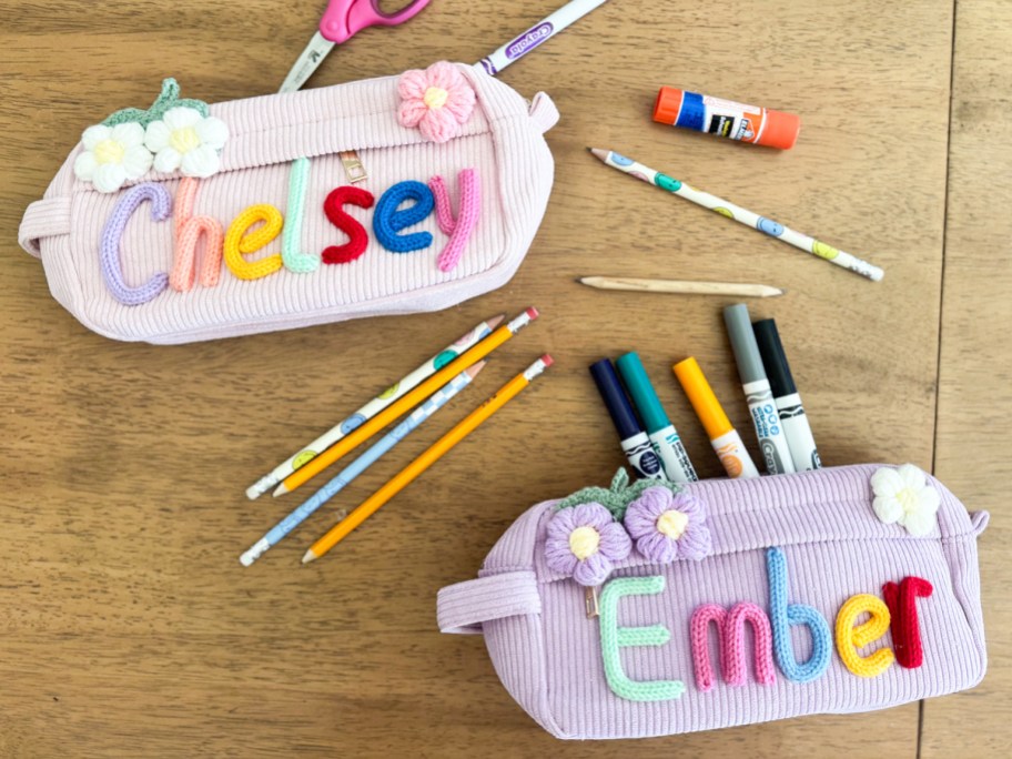 personalized pencil cases on table with school supplies