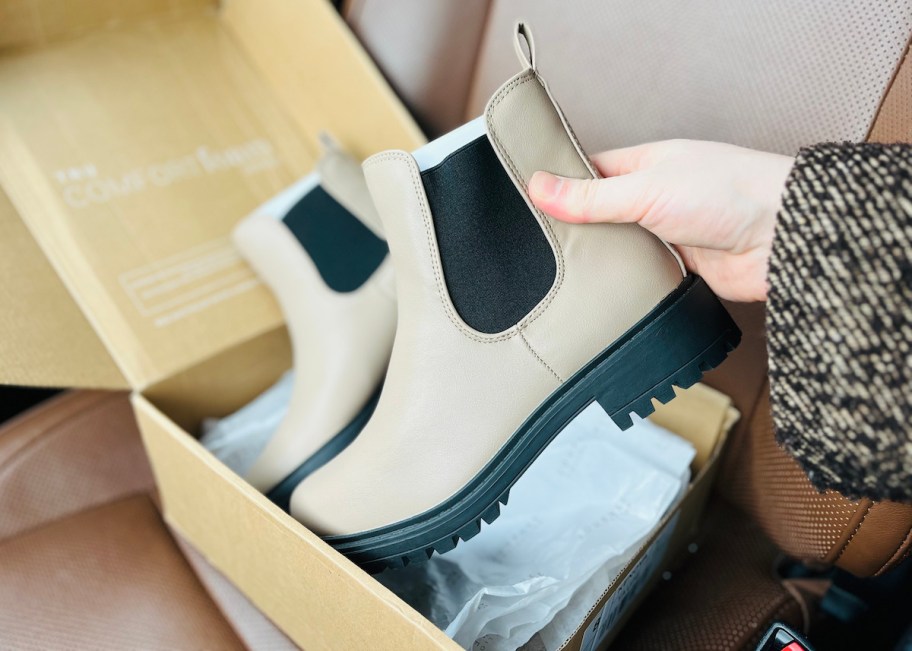 hand holding a beige boot