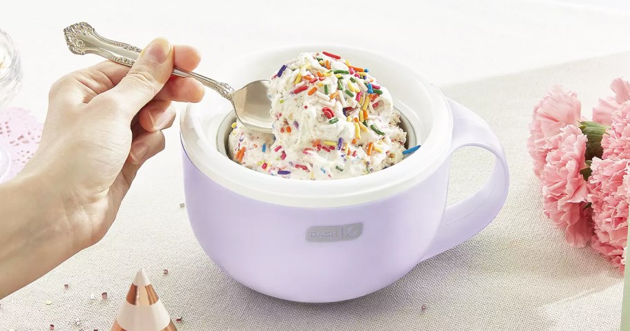 eating ice cream with rainbow sprinkles out of a purple ice cream maker mug