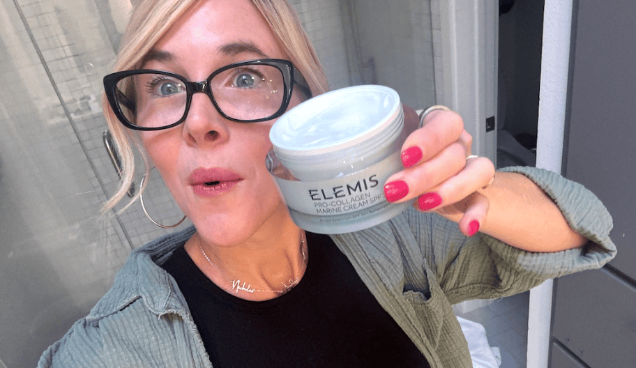 Woman holding elemis pro collagen cream