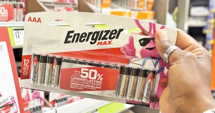 hand holding a set of Energizer Max AAA Batteries in store