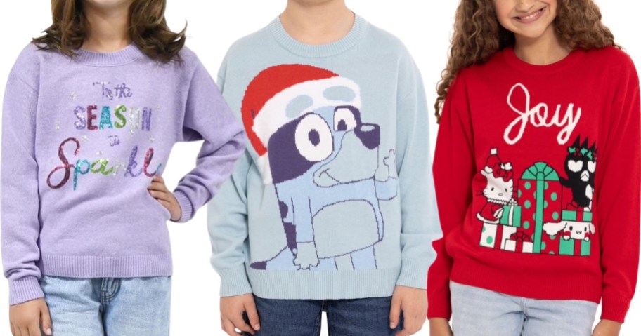 girl wearing a Christmas sweater, boy wearing a Bluey Christmas sweater, and girl wearing a Hello Kitty Christmas sweater