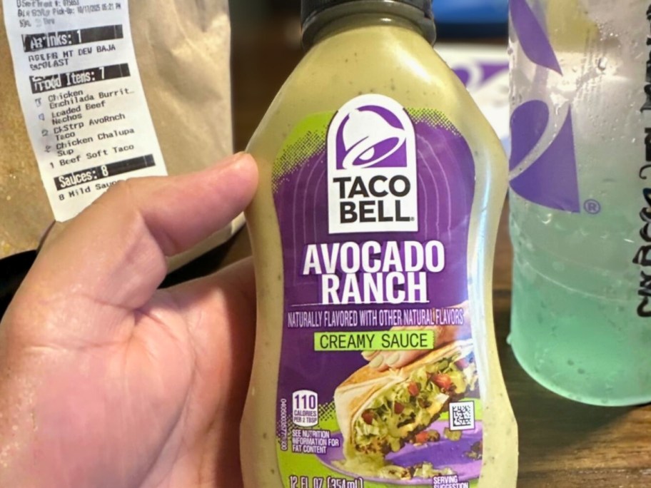 hand holding a bottle of Taco Bell Avocado Ranch Sauce