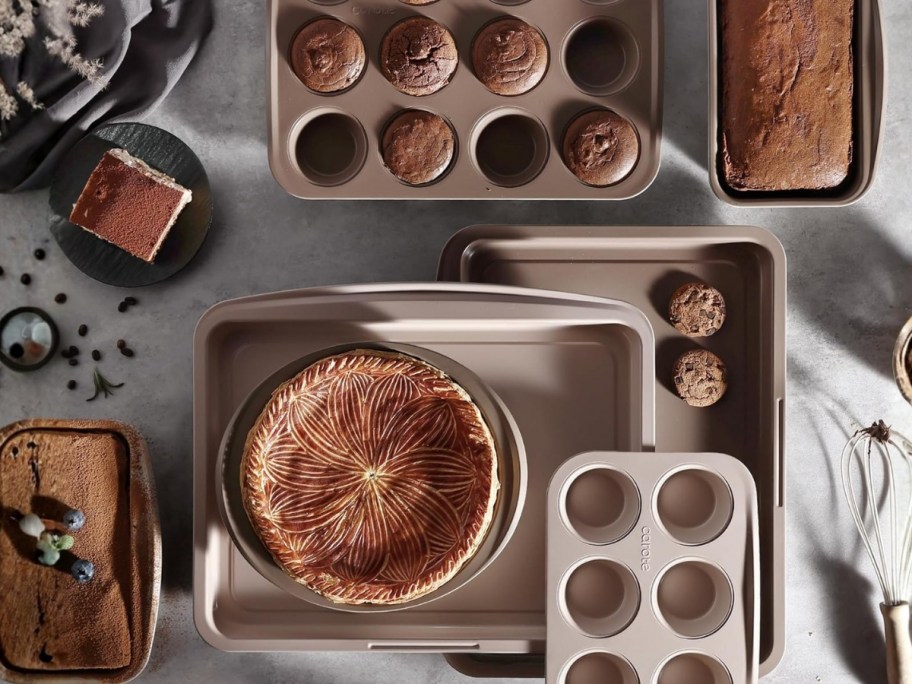 a set of baking sheets, muffin tins, load pans and more with food on them