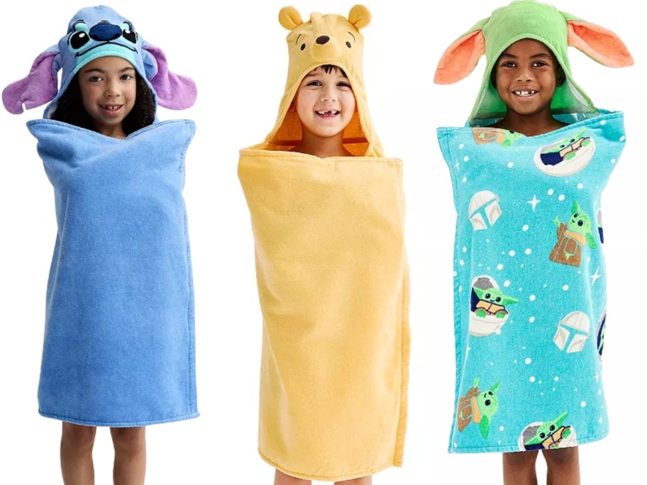3 kids in Disney Stitch, Winnie the Pooh, and Grogu hooded towels