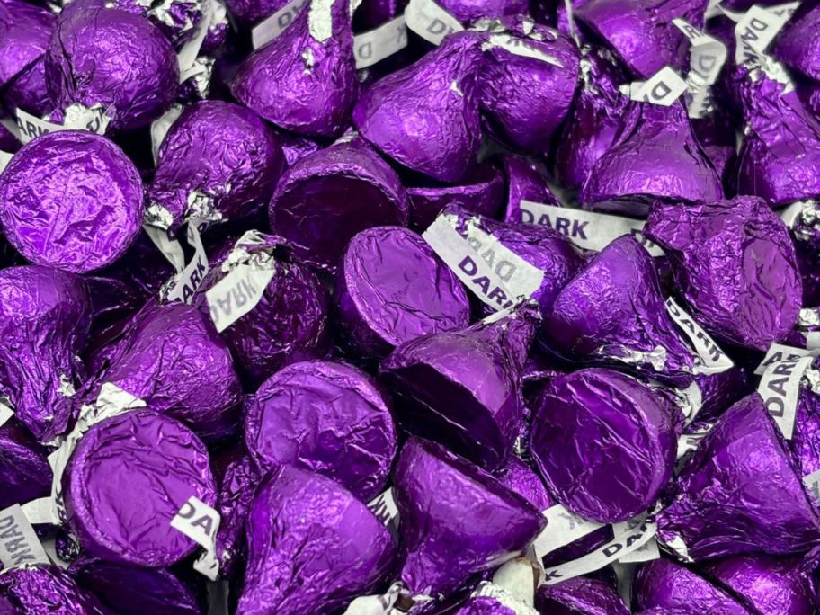 A large pile of Hershey's kisses in purple foil