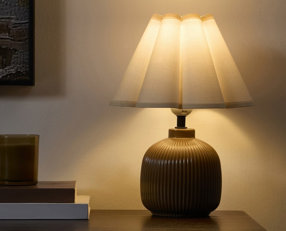Table lamp and dim room with white scallop shade