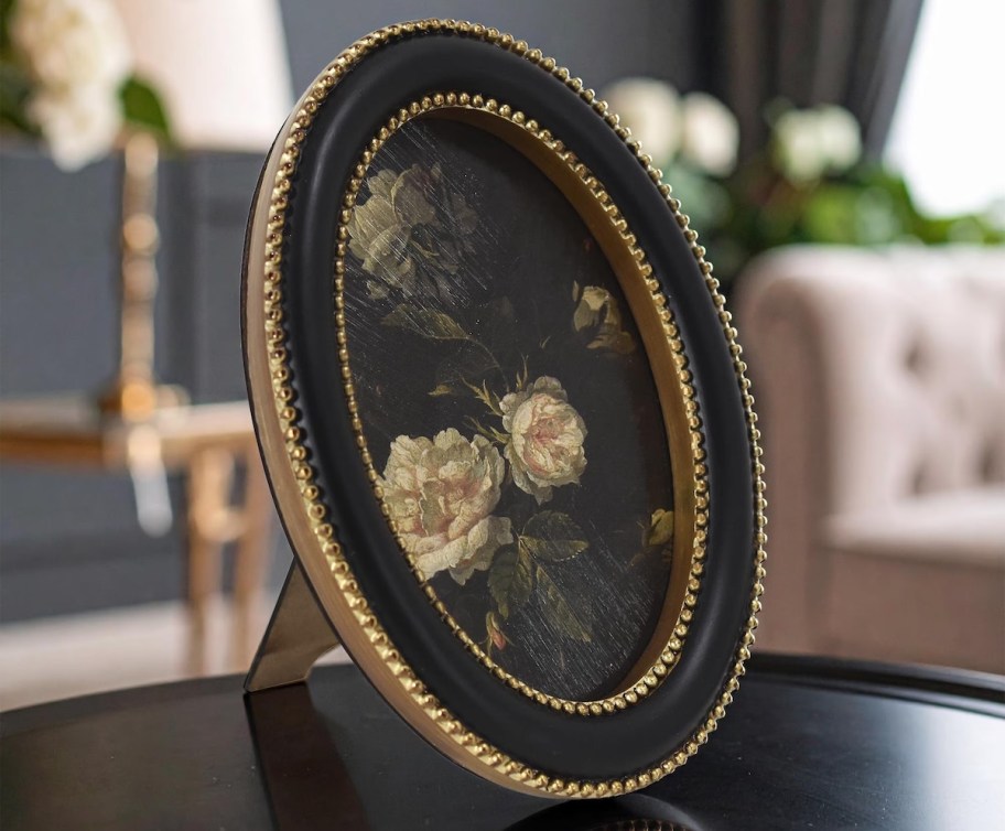 floral oval framed print on table