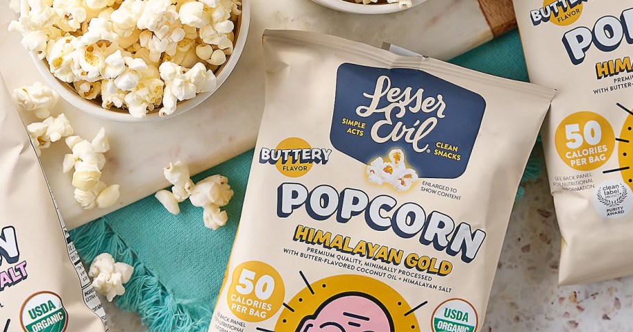 bag of LesserEvil Popcorn near a bowl of popcorn