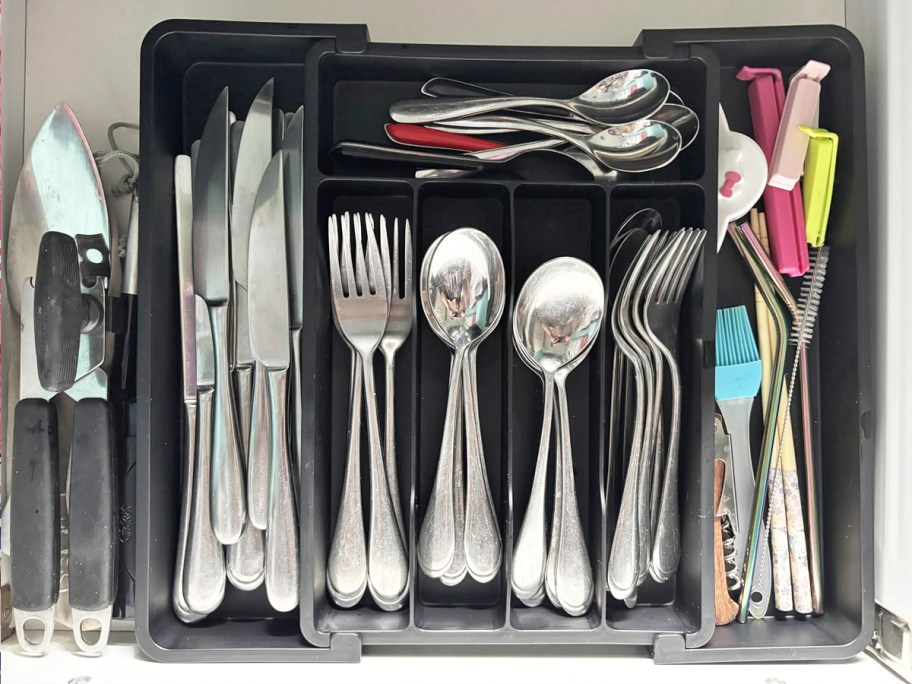 silverware in a black silverware organizer in drawer