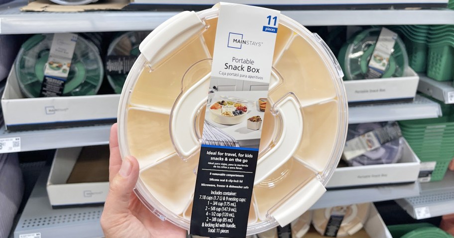 hand holding up a white snackle box in store