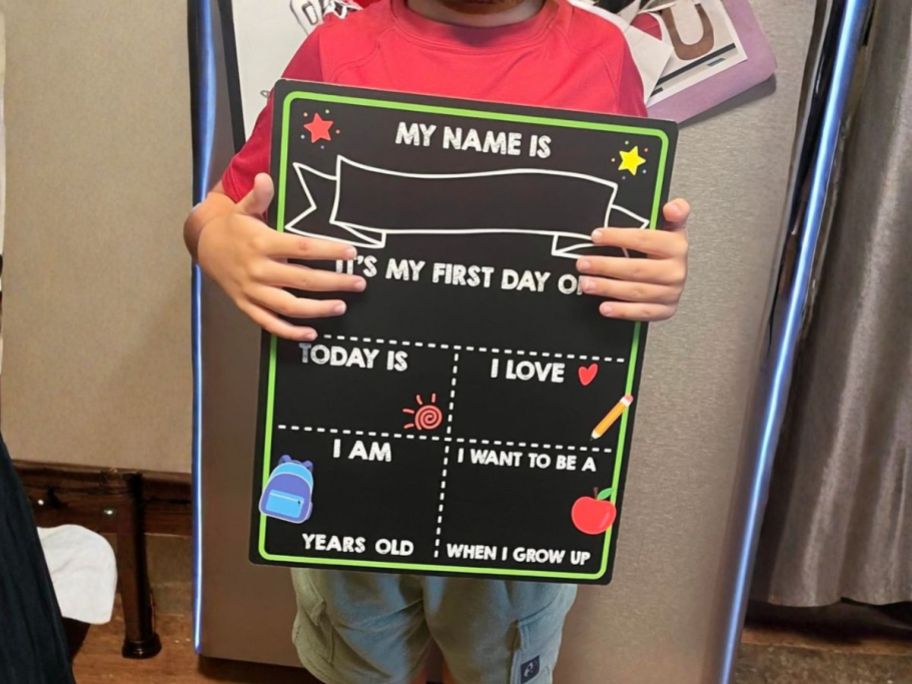kid holding Melisheer Double-Sided First & Last Day of School Chalkboard Sign in kitchen