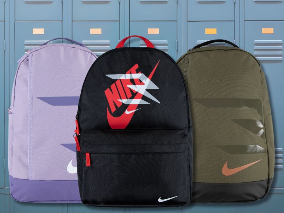 3 Nike backpacks in front of blue lockers