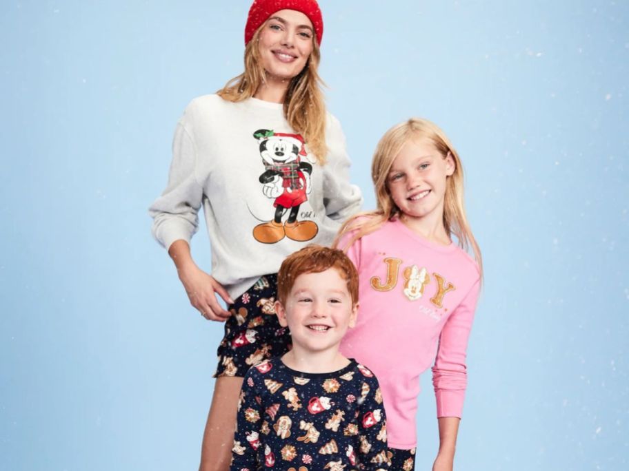 Stock image of a woman and two children wearing Old Navy Disney Hokiday Pajamas