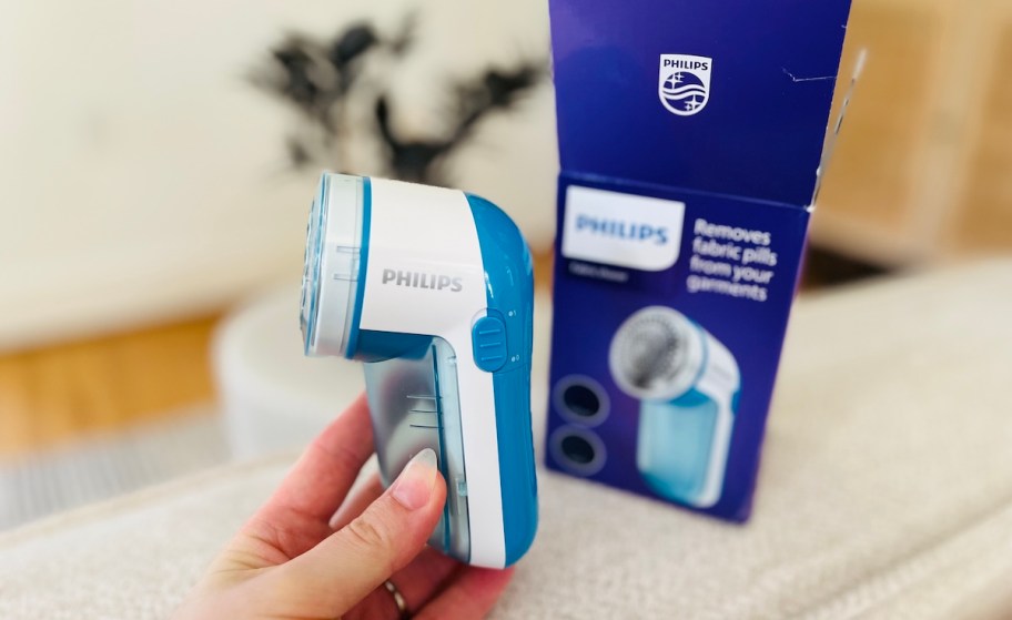 hand holding a philips fabric shaver with box 