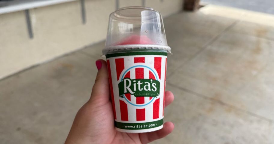hand holding a shirley temple Italian ice