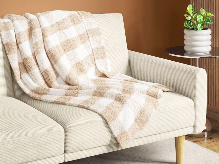 tan and white check throw blanket on a couch
