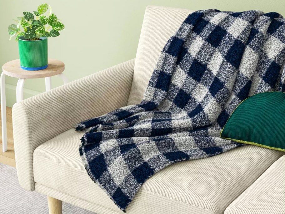 navy and white check throw blanket on a couch