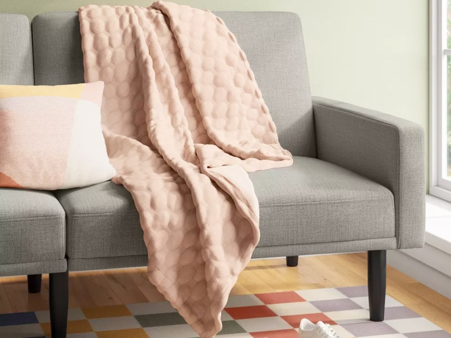 pink throw blanket on a couch