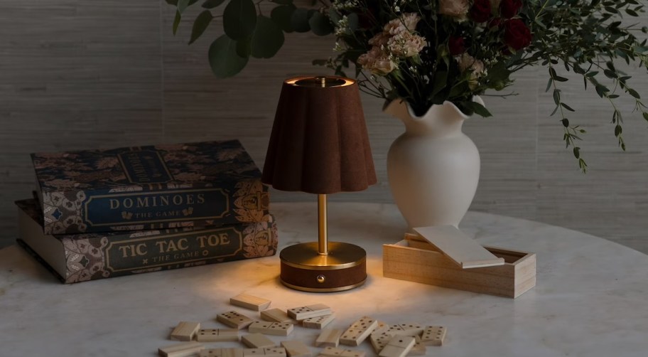 brown mini table lamp with wooden games on table