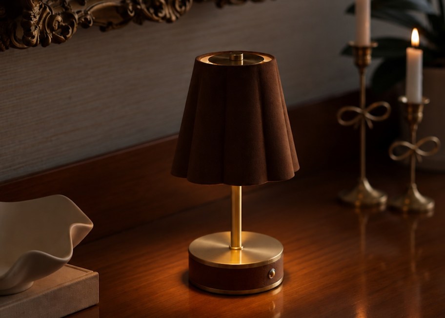 small brown table lamp on wood table with taper candles