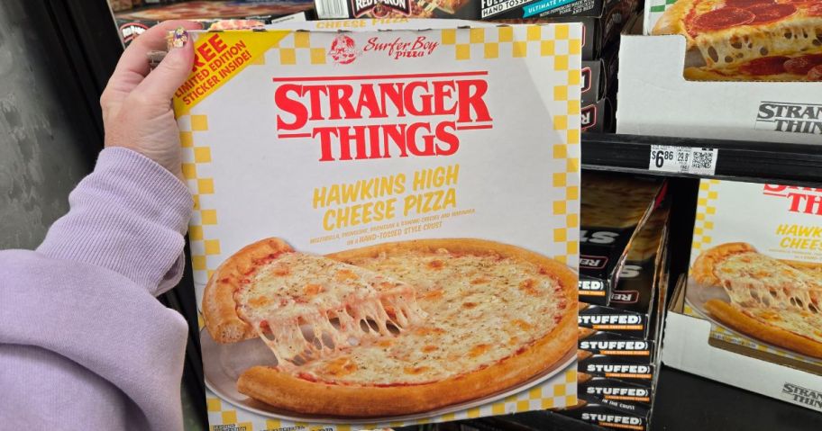 A person holding a Stranger Things Pizza Hawkins High Cheese Pizza