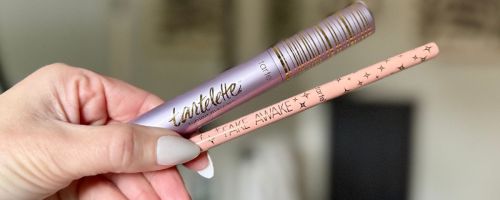 Hand holding a Tarte Tubing Mascara & Fake awake eye brightener