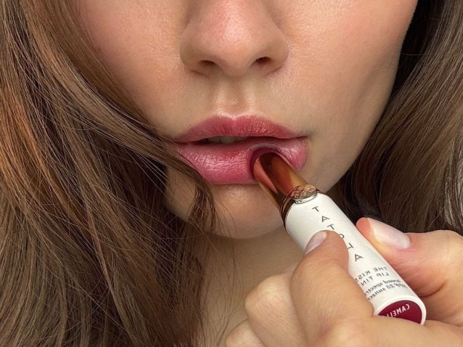 Woman applying a Tatcha Lipstick