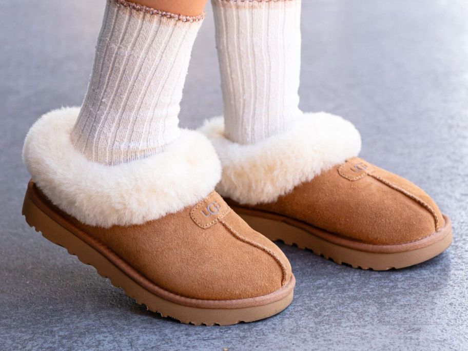 A person wearing brown UGG slippers