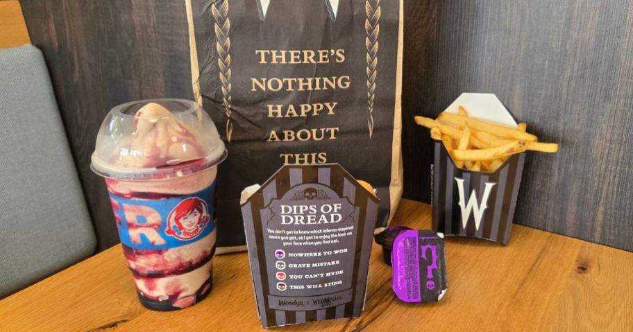 Wendy's Meal of Misfortune Bag with Shake, Nuggets and Fries and Dip in front of it