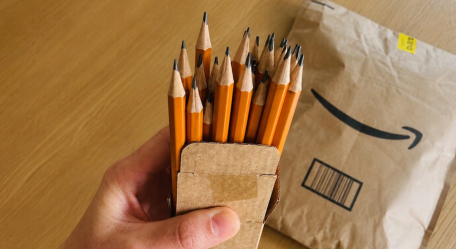 hand holding box of 30 yellow #2 pencils